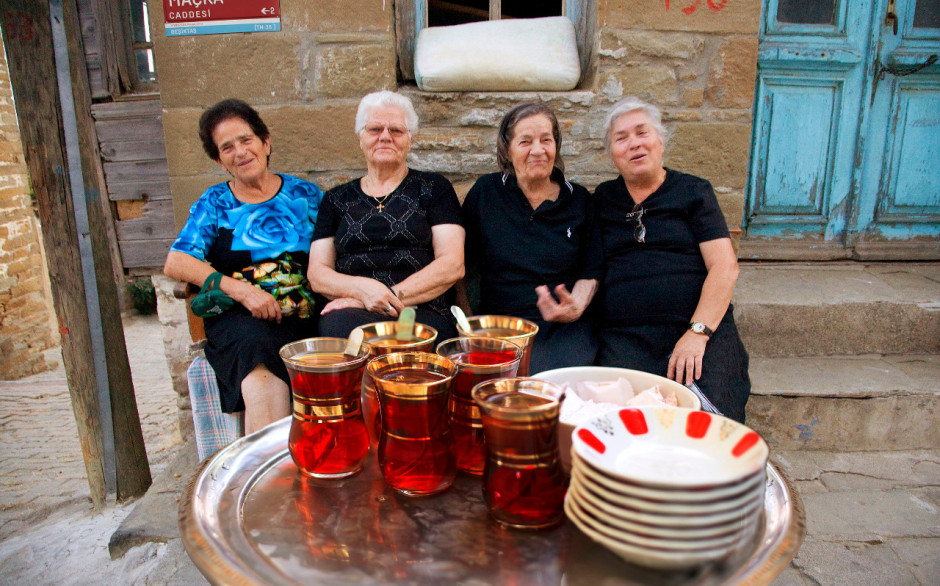 Greek women of Imros island, having Turkish tea and chit-chat in the street in front of their houses, Çanakkale/N.W. Turkey